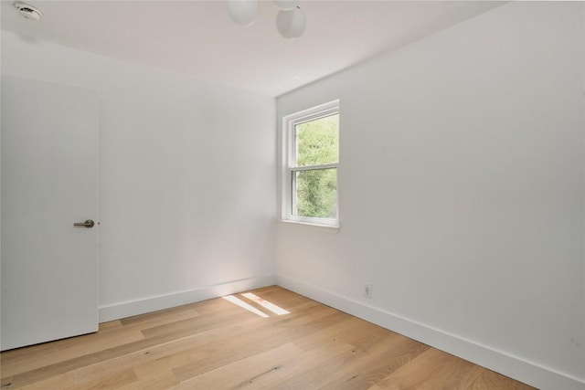 6806 Syracuse Cv, Austin, TX 78723 - empty room with light wood-style floors and a smoke detector