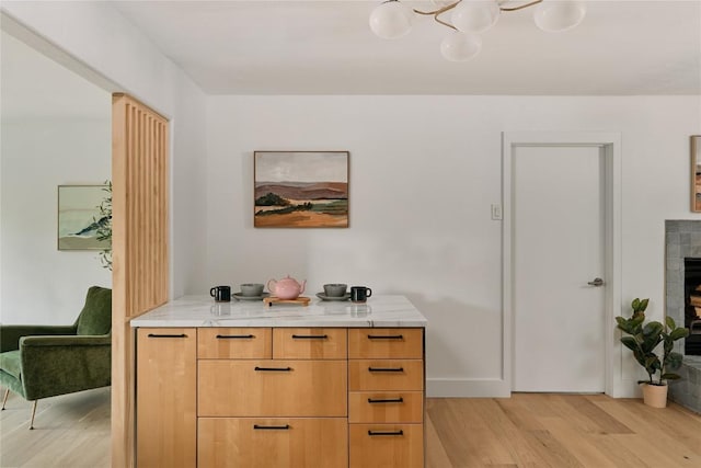 6806 Syracuse Cv, Austin, TX 78723 - detailed view of wood finished floors, a fireplace, and a chandelier