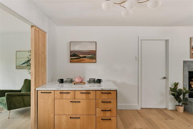 6806 Syracuse Cv, Austin, TX 78723 - detailed view of wood finished floors, a fireplace, and a chandelier