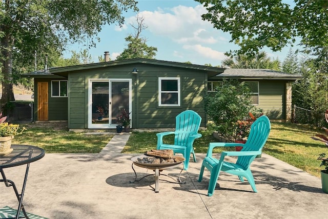 6806 Syracuse Cv, Austin, TX 78723 - rear view of house with an outdoor fire pit and a patio area