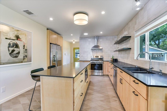 3004 Breeze Ter, Austin, TX 78722 - kitchen with light brown cabinetry, appliances with stainless steel finishes, dark countertops, wall chimney exhaust hood, and recessed lighting