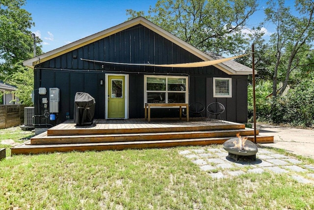 3004 Breeze Ter, Austin, TX 78722 - back of property with a fire pit, board and batten siding, and a wooden deck