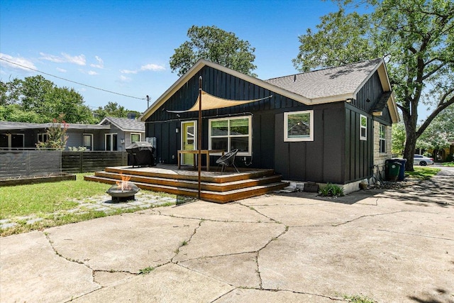 3004 Breeze Ter, Austin, TX 78722 - rear view of property with board and batten siding, a fire pit, a deck, and a patio