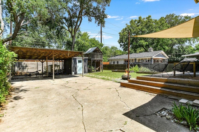 3004 Breeze Ter, Austin, TX 78722 - view of patio with concrete driveway, a detached carport, a storage unit, and a gazebo