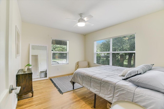 3004 Breeze Ter, Austin, TX 78722 - bedroom with light wood-style floors, multiple windows, and ceiling fan
