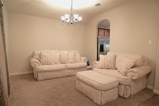 201 Hale Irwin Loop, Round Rock, TX 78664 - carpeted living area featuring arched walkways, a chandelier, and vaulted ceiling
