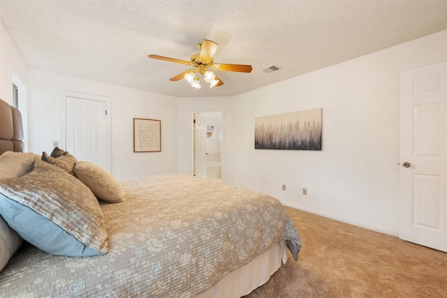 7806 Vail Valley Dr, Austin, TX 78749 - bedroom with carpet floors, a textured ceiling, ceiling fan, and ensuite bath