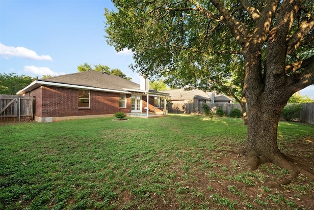 7806 Vail Valley Dr, Austin, TX 78749 - rear view of property featuring french doors, brick siding, a fenced backyard, and a patio
