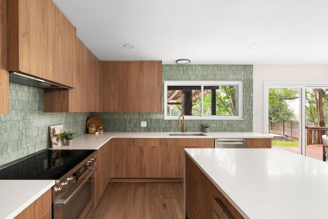 10006 Mandeville Cir, Austin, TX 78750 - kitchen with modern cabinets, stainless steel appliances, brown cabinets, light countertops, and light wood-style floors