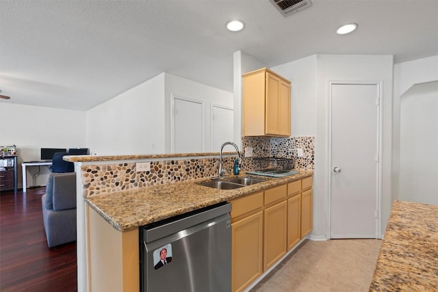 6005 La Mesa St, Leander, TX 78645 - kitchen featuring dishwasher, light brown cabinetry, open floor plan, decorative backsplash, and a peninsula
