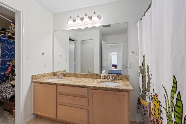 6005 La Mesa St, Leander, TX 78645 - full bathroom featuring double vanity, a spacious closet, and ensuite bath