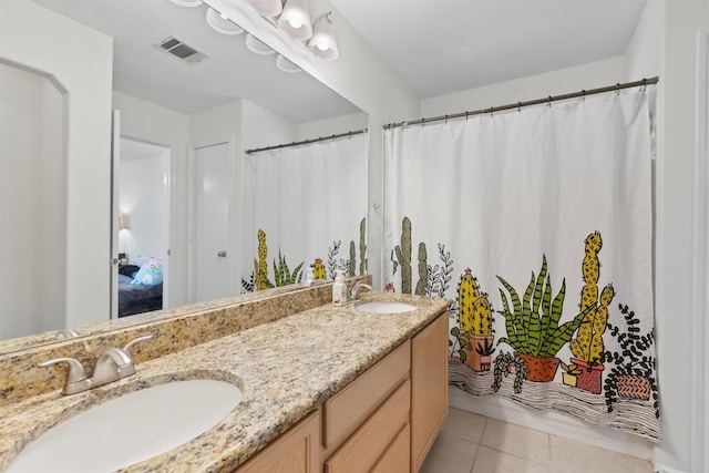 6005 La Mesa St, Leander, TX 78645 - bathroom featuring double vanity, tile patterned flooring, and a shower with shower curtain