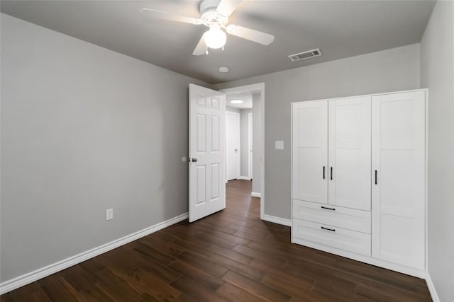 106 Harper Dr, Bastrop, TX 78602 - unfurnished bedroom with dark wood-type flooring, a ceiling fan, and a closet