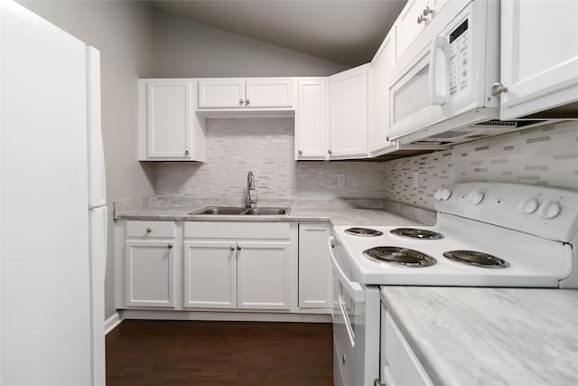 106 Harper Dr, Bastrop, TX 78602 - kitchen with white appliances, light countertops, vaulted ceiling, decorative backsplash, and white cabinets