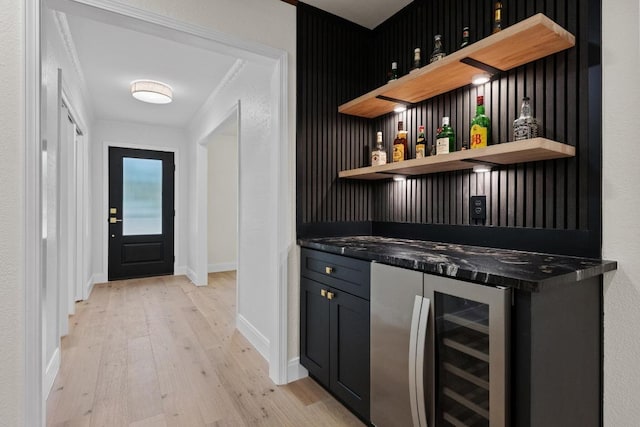 8909 Laurel Grove Dr, Austin, TX 78758 - indoor dry bar with wine cooler and light wood-style floors
