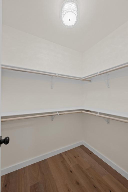 8909 Laurel Grove Dr, Austin, TX 78758 - walk in closet with wood finished floors