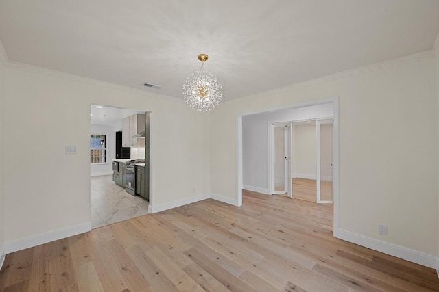 8909 Laurel Grove Dr, Austin, TX 78758 - spare room with a chandelier, light wood finished floors, and ornamental molding