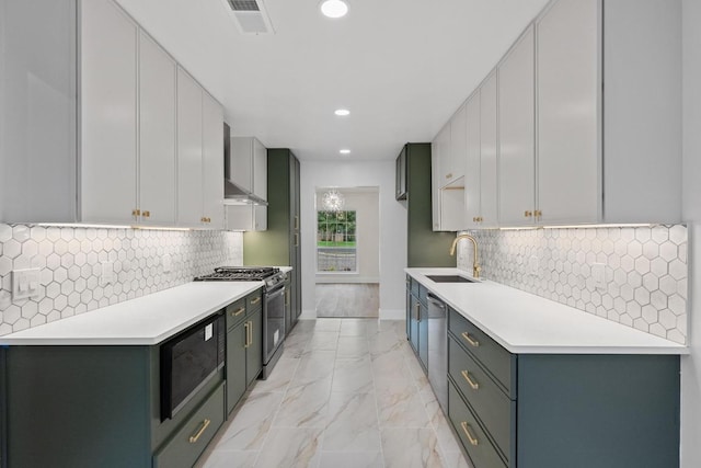 8909 Laurel Grove Dr, Austin, TX 78758 - kitchen with appliances with stainless steel finishes, wall chimney range hood, recessed lighting, light countertops, and light marble finish floors