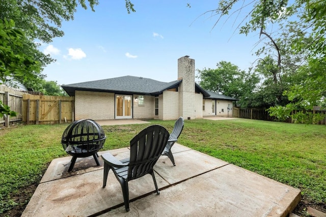 8909 Laurel Grove Dr, Austin, TX 78758 - back of house featuring a patio area, a chimney, an outdoor fire pit, a fenced backyard, and brick siding