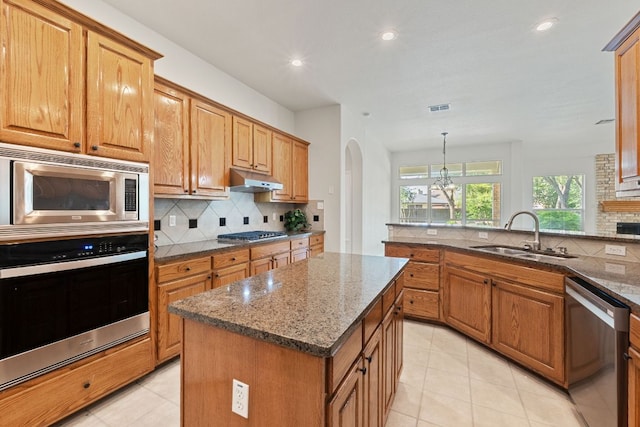 2700 Dagama Ct, Cedar Park, TX 78613 - kitchen with stainless steel appliances, tasteful backsplash, light tile patterned flooring, dark stone counters, and recessed lighting