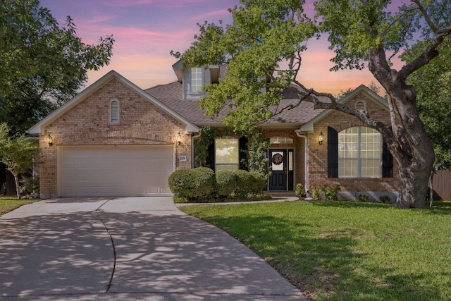 2700 Dagama Ct, Cedar Park, TX 78613 - view of front of house with brick siding, concrete driveway, a yard, a garage, and roof with shingles