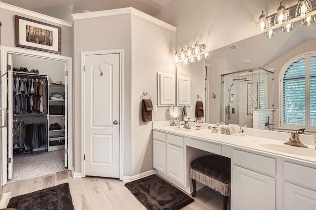 4231 N Summercrest Loop, Round Rock, TX 78681 - full bathroom with a shower stall, double vanity, a walk in closet, and wood finished floors