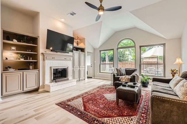 4231 N Summercrest Loop, Round Rock, TX 78681 - living room featuring ceiling fan, light wood finished floors, a fireplace, and vaulted ceiling