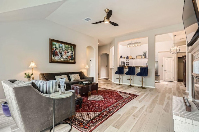 4231 N Summercrest Loop, Round Rock, TX 78681 - living area featuring arched walkways, light wood-style floors, and a ceiling fan