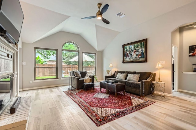 4231 N Summercrest Loop, Round Rock, TX 78681 - living room featuring arched walkways, light wood finished floors, a ceiling fan, and lofted ceiling