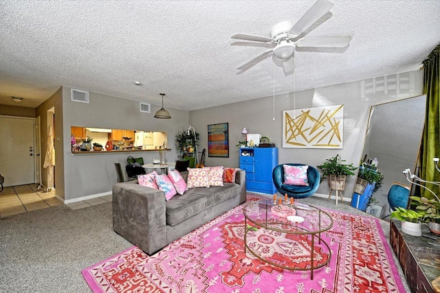 7825 Beauregard Cir Unit 26, Austin, TX 78745 - carpeted living area featuring ceiling fan and a textured ceiling