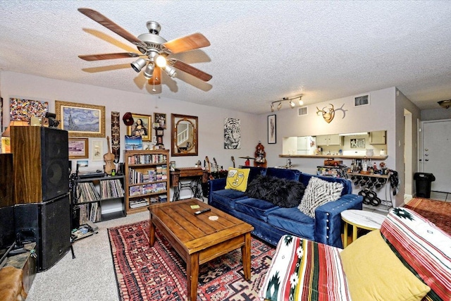7825 Beauregard Cir Unit 26, Austin, TX 78745 - living room featuring carpet, a textured ceiling, and a ceiling fan