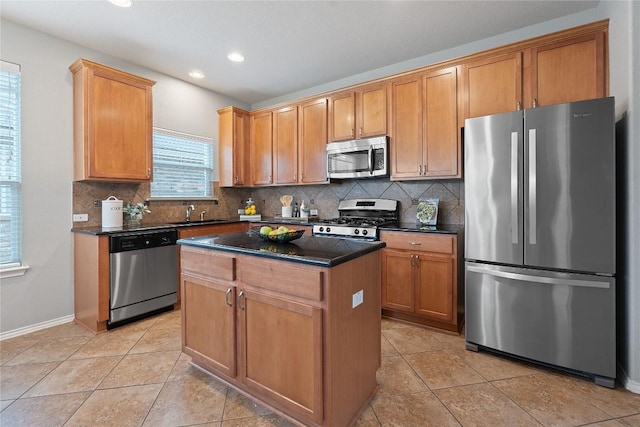 11221 Old Quarry Rd, Austin, TX 78717 - kitchen with appliances with stainless steel finishes, a center island, tasteful backsplash, recessed lighting, and light tile patterned floors