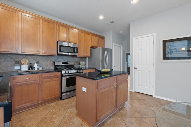 11221 Old Quarry Rd, Austin, TX 78717 - kitchen with appliances with stainless steel finishes, decorative backsplash, light tile patterned floors, a center island, and brown cabinetry