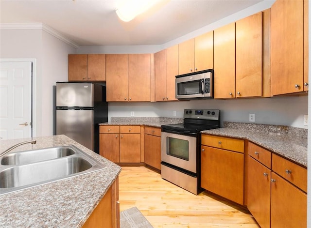 2502 Leon St Unit 305, Austin, TX 78705 - kitchen with stainless steel appliances, light wood finished floors, and ornamental molding