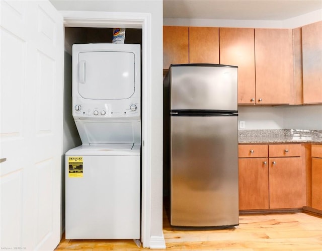 2502 Leon St Unit 305, Austin, TX 78705 - laundry area with stacked washer / dryer and light wood finished floors