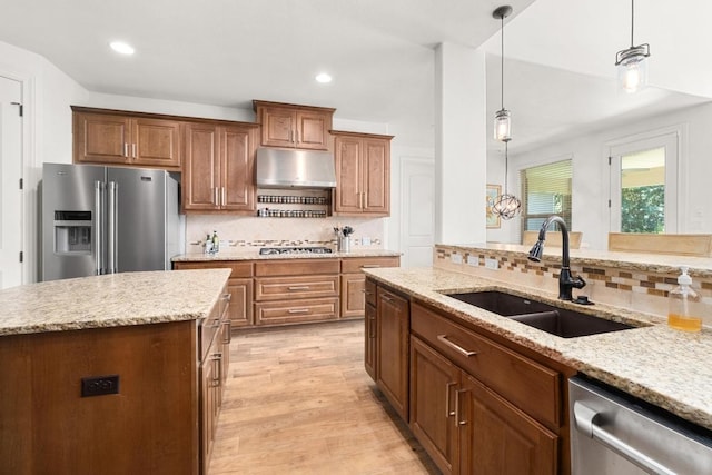 174 Jayne Cv, Austin, TX 78737 - kitchen featuring appliances with stainless steel finishes, backsplash, under cabinet range hood, pendant lighting, and recessed lighting