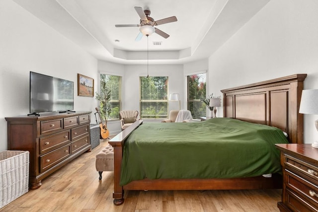 174 Jayne Cv, Austin, TX 78737 - bedroom with a tray ceiling, light wood finished floors, and ceiling fan