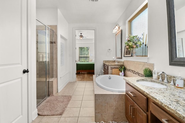 174 Jayne Cv, Austin, TX 78737 - bathroom with a stall shower, two vanities, a bath, tile patterned flooring, and ceiling fan