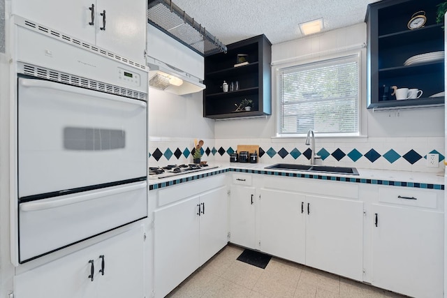 932 E 53 1/2 St, Austin, TX 78751 - kitchen with a warming drawer, open shelves, white appliances, and tasteful backsplash