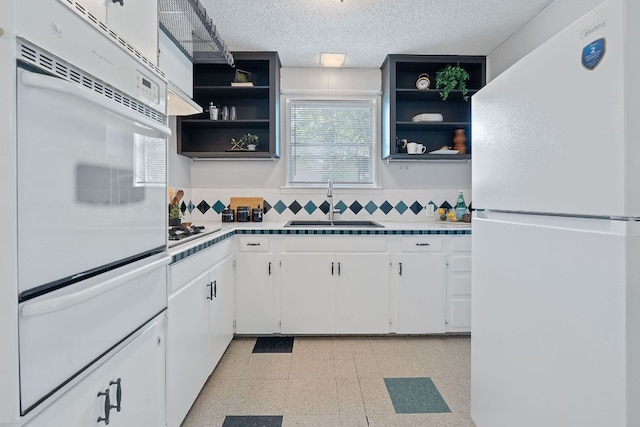 932 E 53 1/2 St, Austin, TX 78751 - kitchen featuring white appliances, a warming drawer, open shelves, white cabinetry, and light flooring