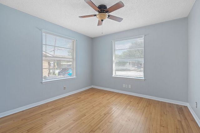 932 E 53 1/2 St, Austin, TX 78751 - empty room with light wood-style floors, plenty of natural light, a ceiling fan, and a textured ceiling