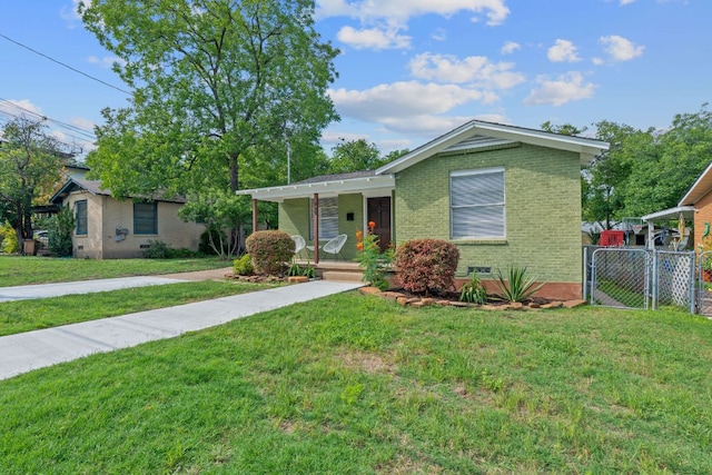 932 E 53 1/2 St, Austin, TX 78751 - view of front of home featuring a porch, brick siding, and a gate