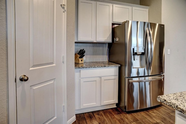 508 Bluffview Dr, Bastrop, TX 78602 - kitchen with stainless steel refrigerator with ice dispenser, dark wood finished floors, and light stone counters