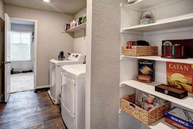 508 Bluffview Dr, Bastrop, TX 78602 - washroom with dark wood finished floors, separate washer and dryer, and a textured wall