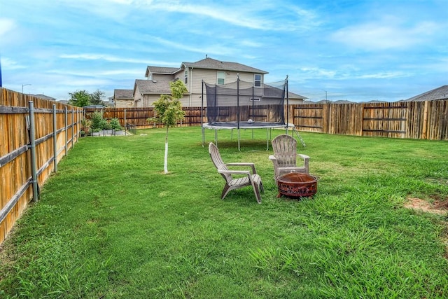 508 Bluffview Dr, Bastrop, TX 78602 - fenced backyard featuring a trampoline and a fire pit