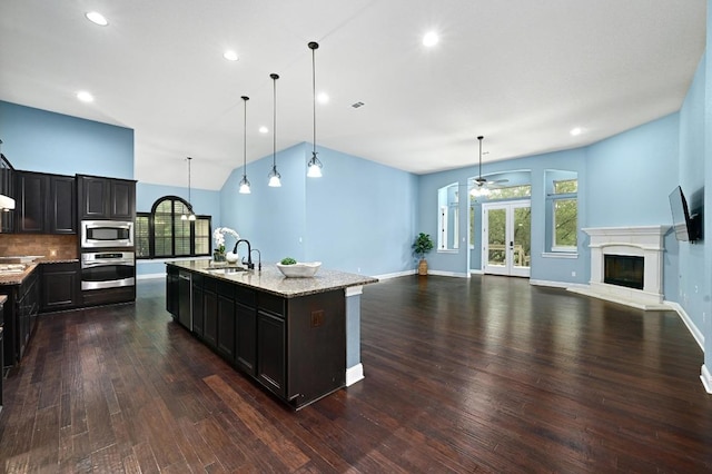 204 Lake Como Dr, Austin, TX 78734 - kitchen with stainless steel appliances, dark wood-style floors, healthy amount of natural light, open floor plan, and recessed lighting