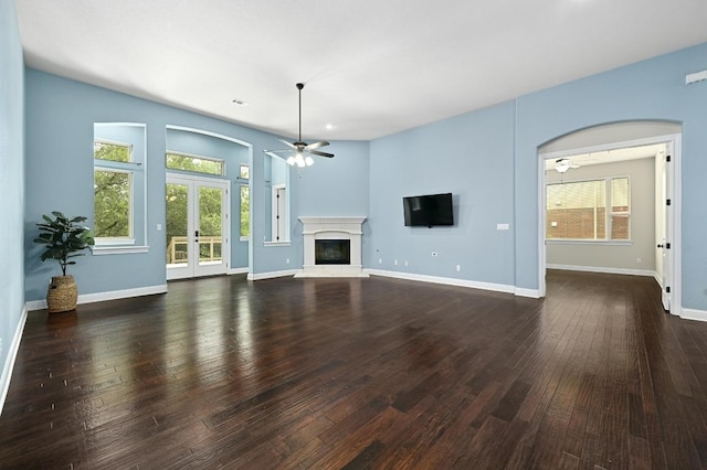 204 Lake Como Dr, Austin, TX 78734 - unfurnished living room with ceiling fan, healthy amount of natural light, french doors, and a glass covered fireplace