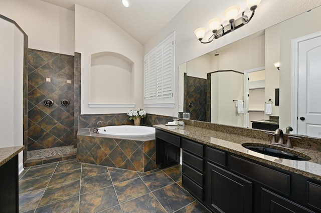 204 Lake Como Dr, Austin, TX 78734 - full bath with walk in shower, double vanity, a garden tub, lofted ceiling, and stone finish flooring
