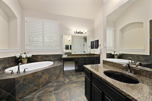 204 Lake Como Dr, Austin, TX 78734 - full bathroom with two vanities, a bath, and lofted ceiling