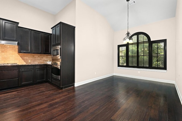 204 Lake Como Dr, Austin, TX 78734 - kitchen with stainless steel appliances, light stone counters, dark wood-style flooring, backsplash, and lofted ceiling